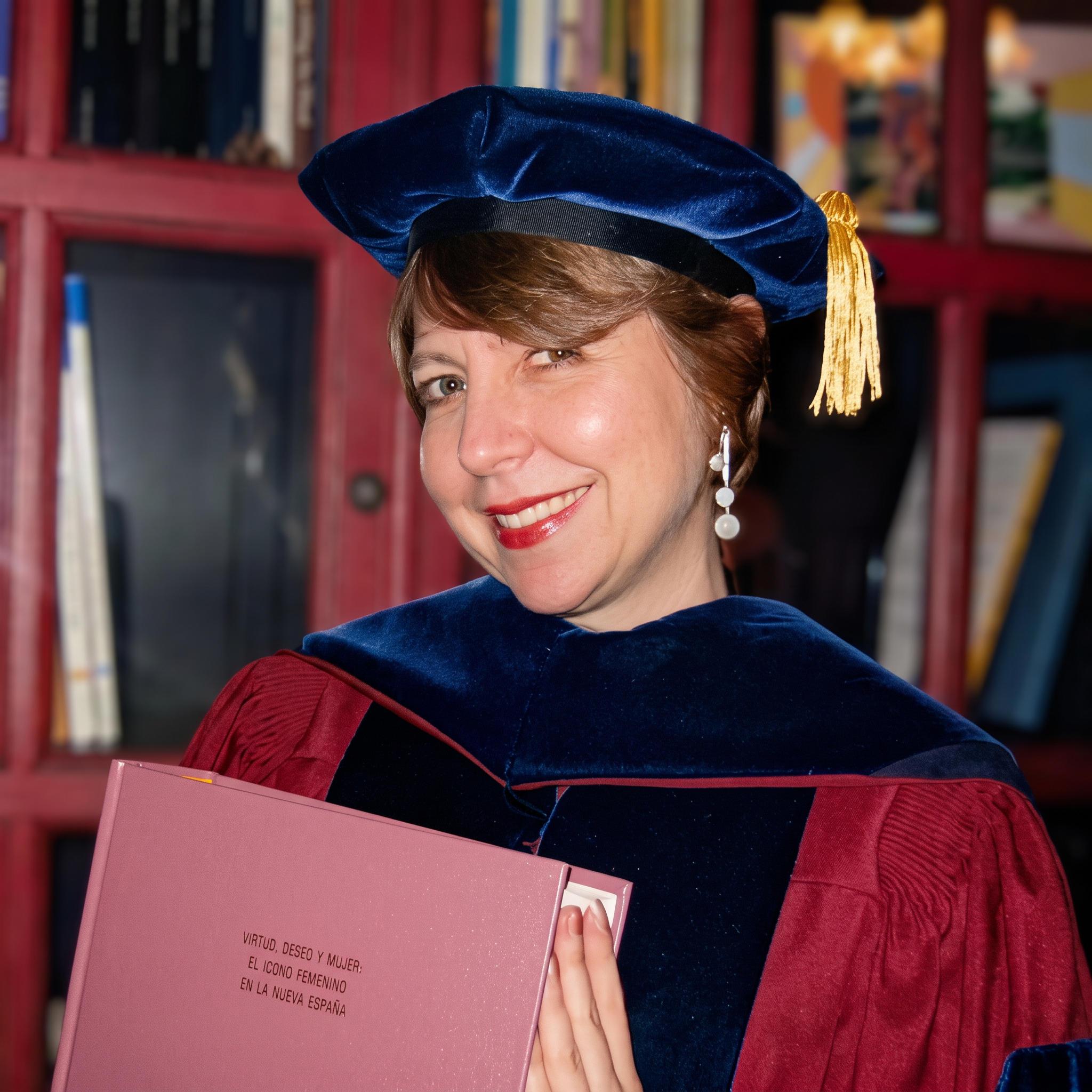 María Luisa in doctoral regalia holding her dissertation, PhD 2002